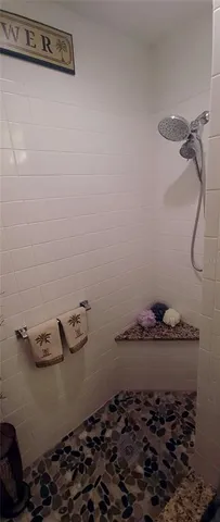 a bathroom with a granite countertop sink and cabinets