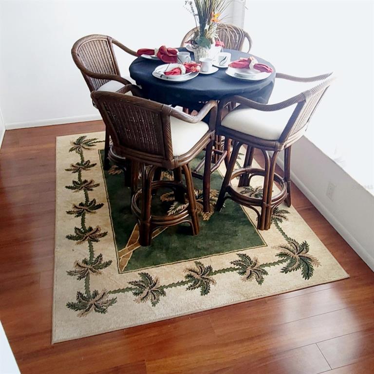 6543 Pine Walk Drive New Port Richey, FL 34655 - Photo 4 of 21 a view of a dining room with furniture and wooden floor