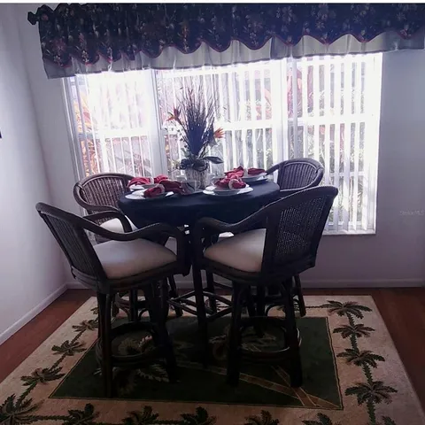 a view of a dining room with furniture and window