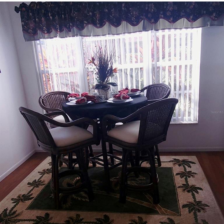 6543 Pine Walk Drive New Port Richey, FL 34655 - Photo 5 of 21 a view of a dining room with furniture and window
