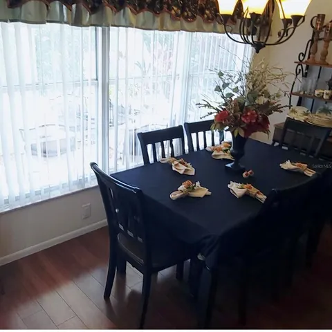 a view of a dining table and chairs in the patio