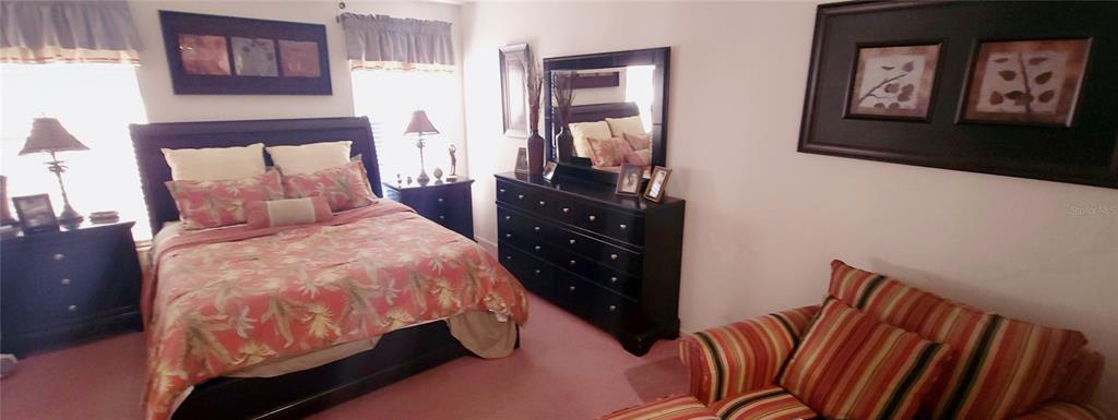 6543 Pine Walk Drive New Port Richey, FL 34655 - Photo 8 of 21 a bed sitting in a bedroom next to a window