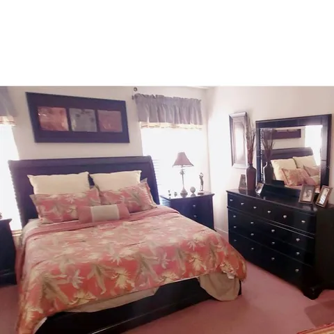 a bedroom with a bed and a dresser