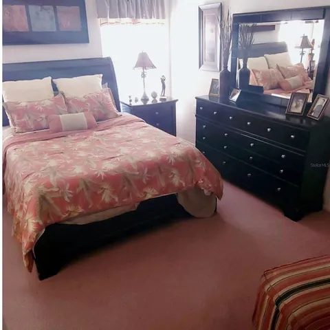 a bedroom with a bed and a dresser