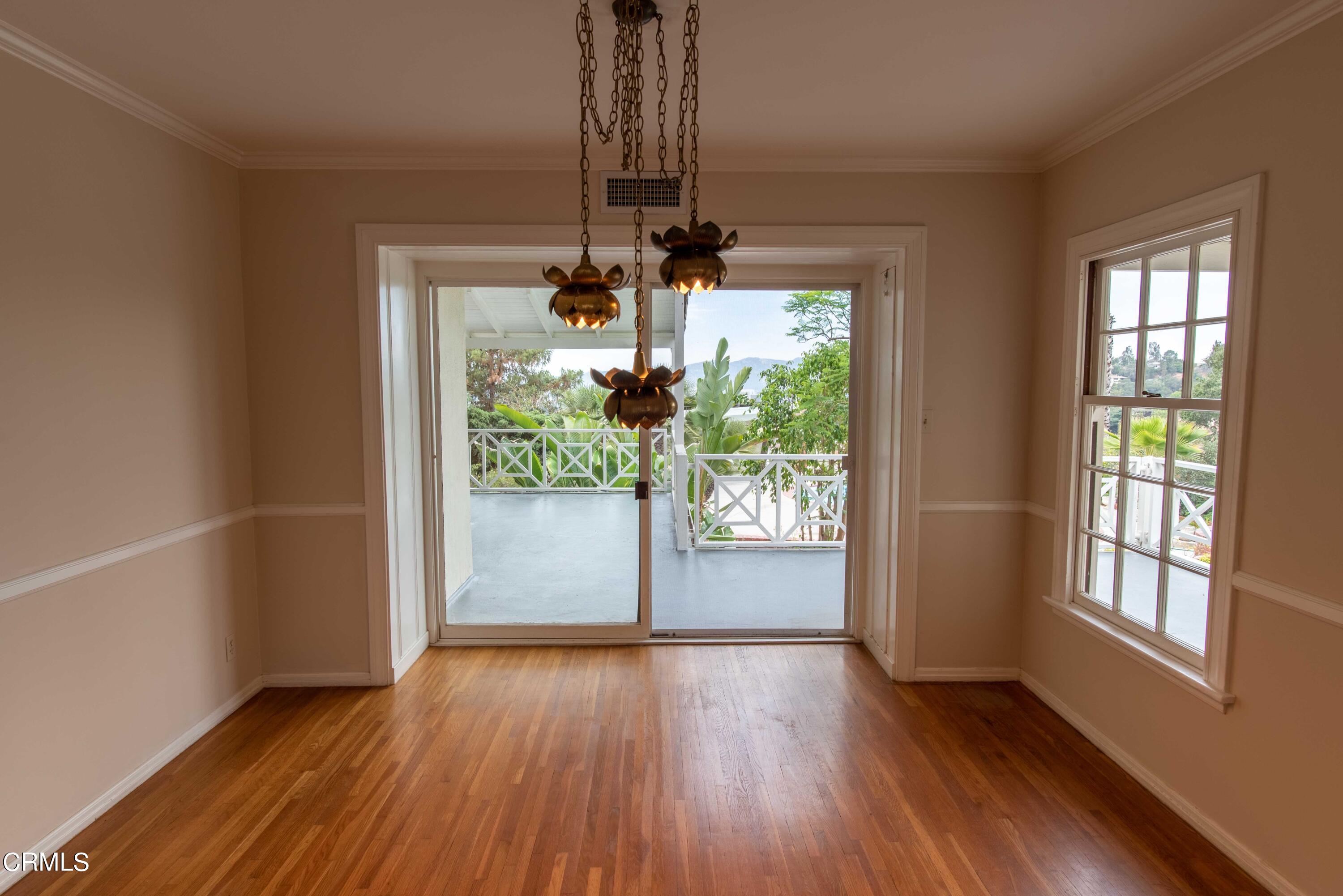 1521 Roca Drive Glendale, CA 91207 - Photo 13 of 54 an empty room with wooden floor and windows