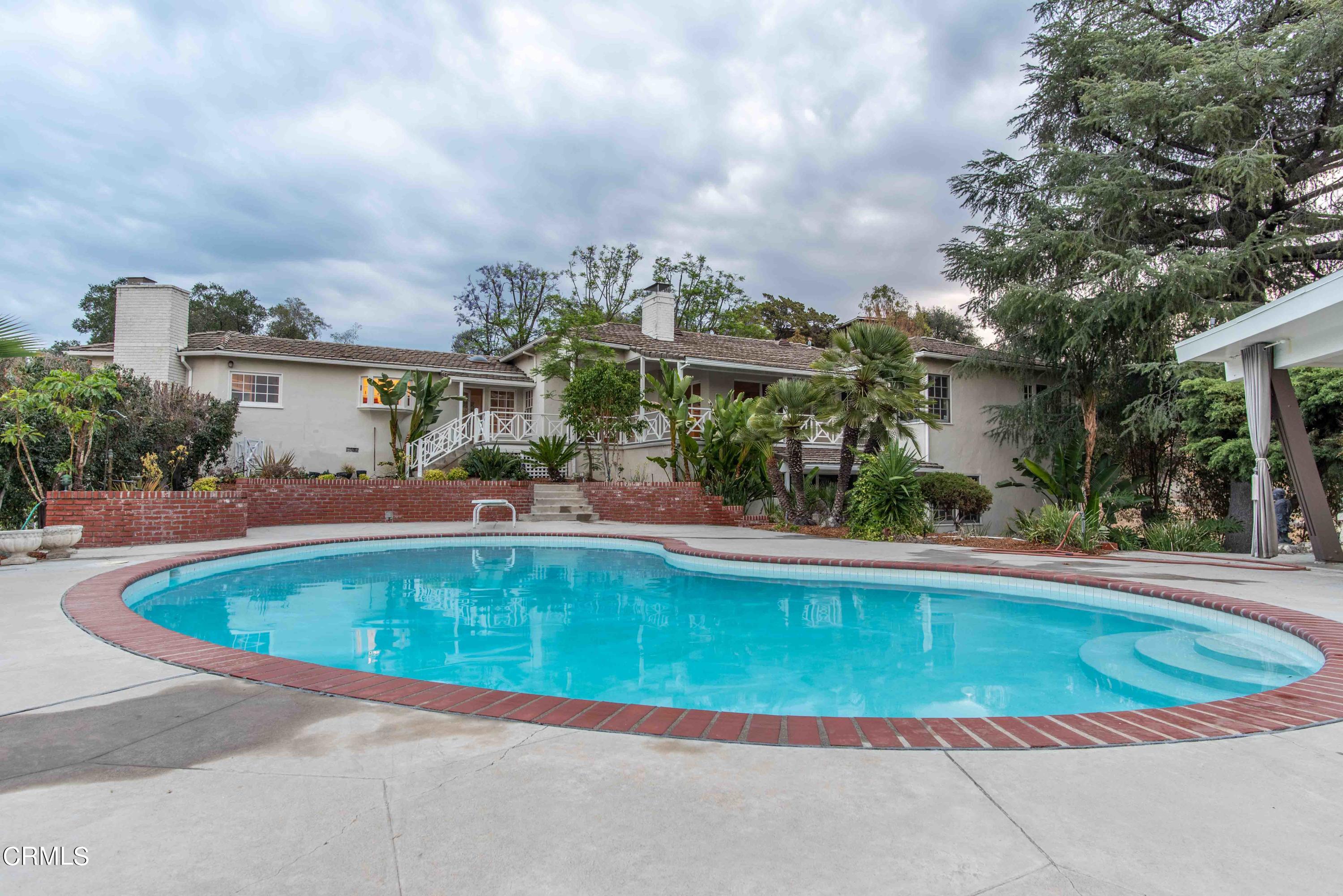 1521 Roca Drive Glendale, CA 91207 - Photo 22 of 54 a view of pool with lawn chairs and large trees