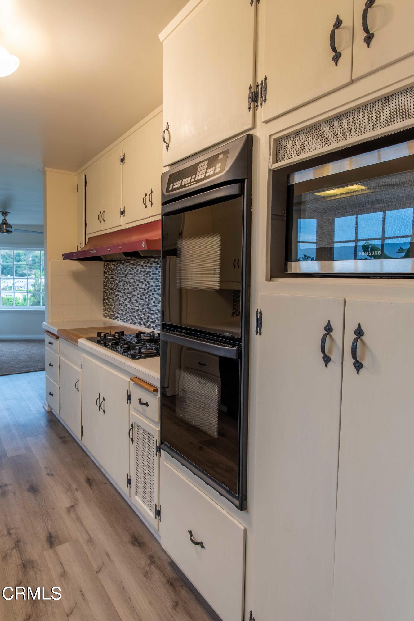 1521 Roca Drive Glendale, CA 91207 - Photo 24 of 54 a kitchen with granite countertop white cabinets stainless steel appliances and a counter space