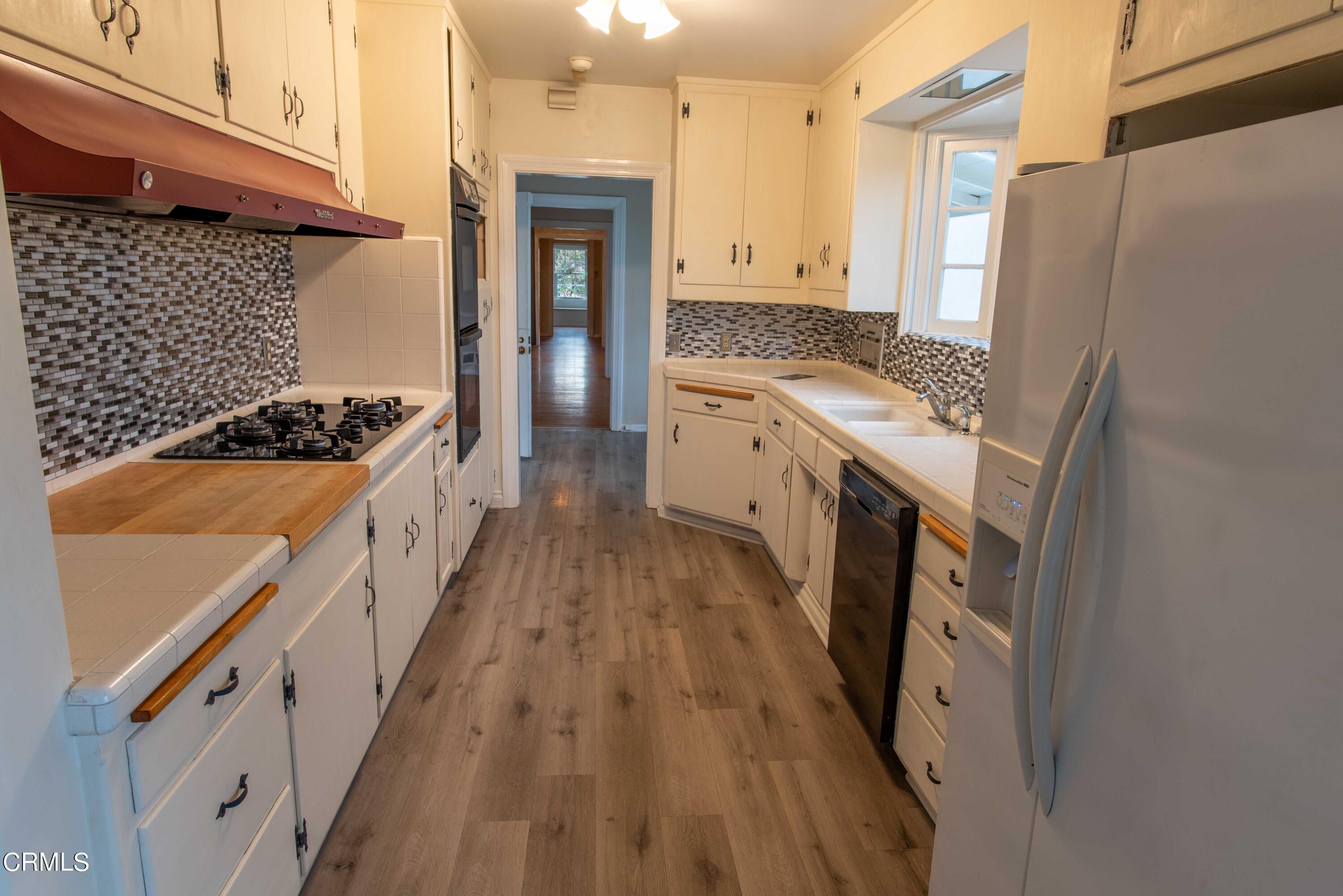 1521 Roca Drive Glendale, CA 91207 - Photo 32 of 54 a kitchen with granite countertop a sink stove and refrigerator