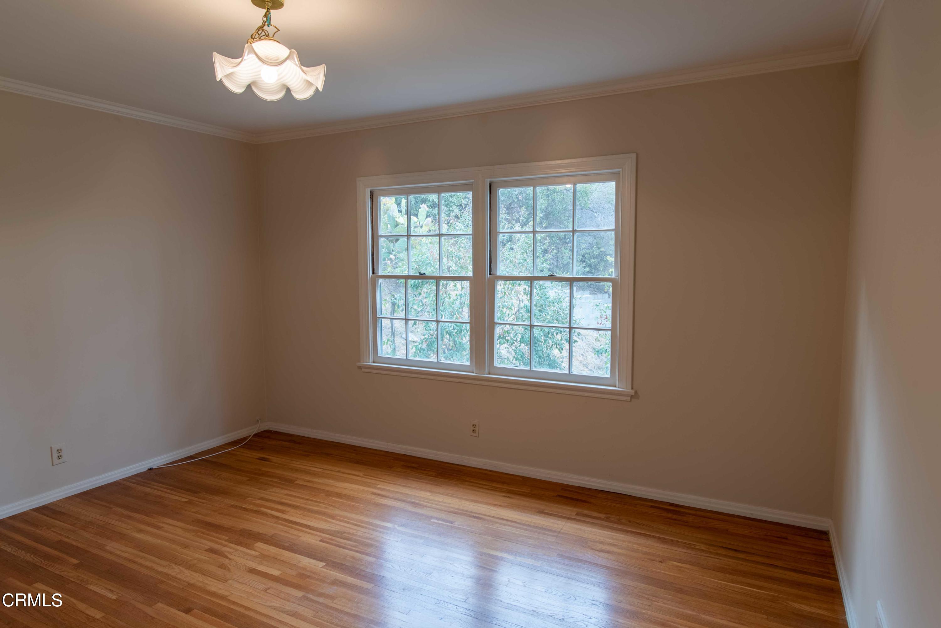 1521 Roca Drive Glendale, CA 91207 - Photo 35 of 54 an empty room with wooden floor and windows