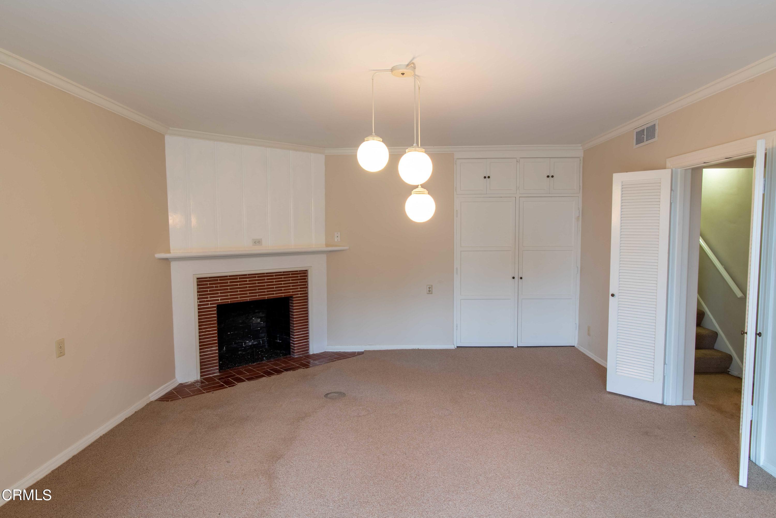 1521 Roca Drive Glendale, CA 91207 - Photo 39 of 54 a view of an empty room with a fireplace and a window