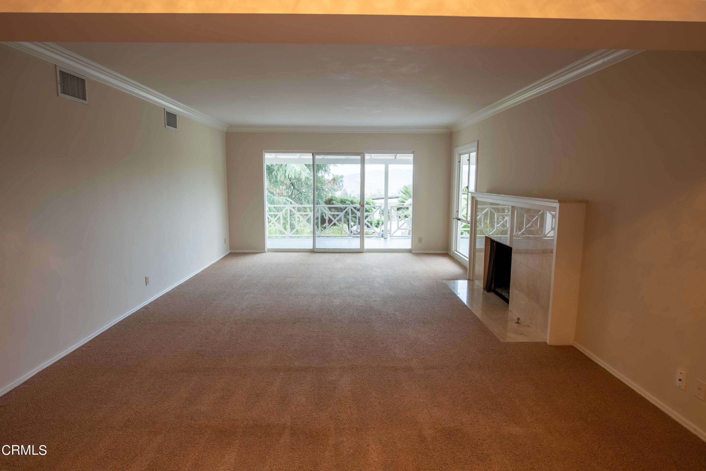 1521 Roca Drive Glendale, CA 91207 - Photo 8 of 54 a view of an empty room with a fireplace and a window