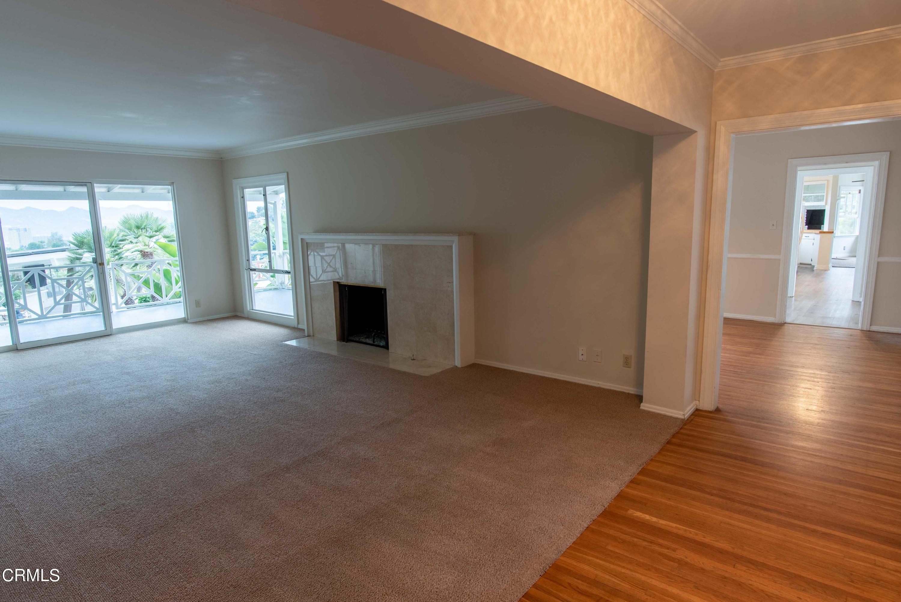 1521 Roca Drive Glendale, CA 91207 - Photo 9 of 54 a view of empty room with wooden floor and fireplace
