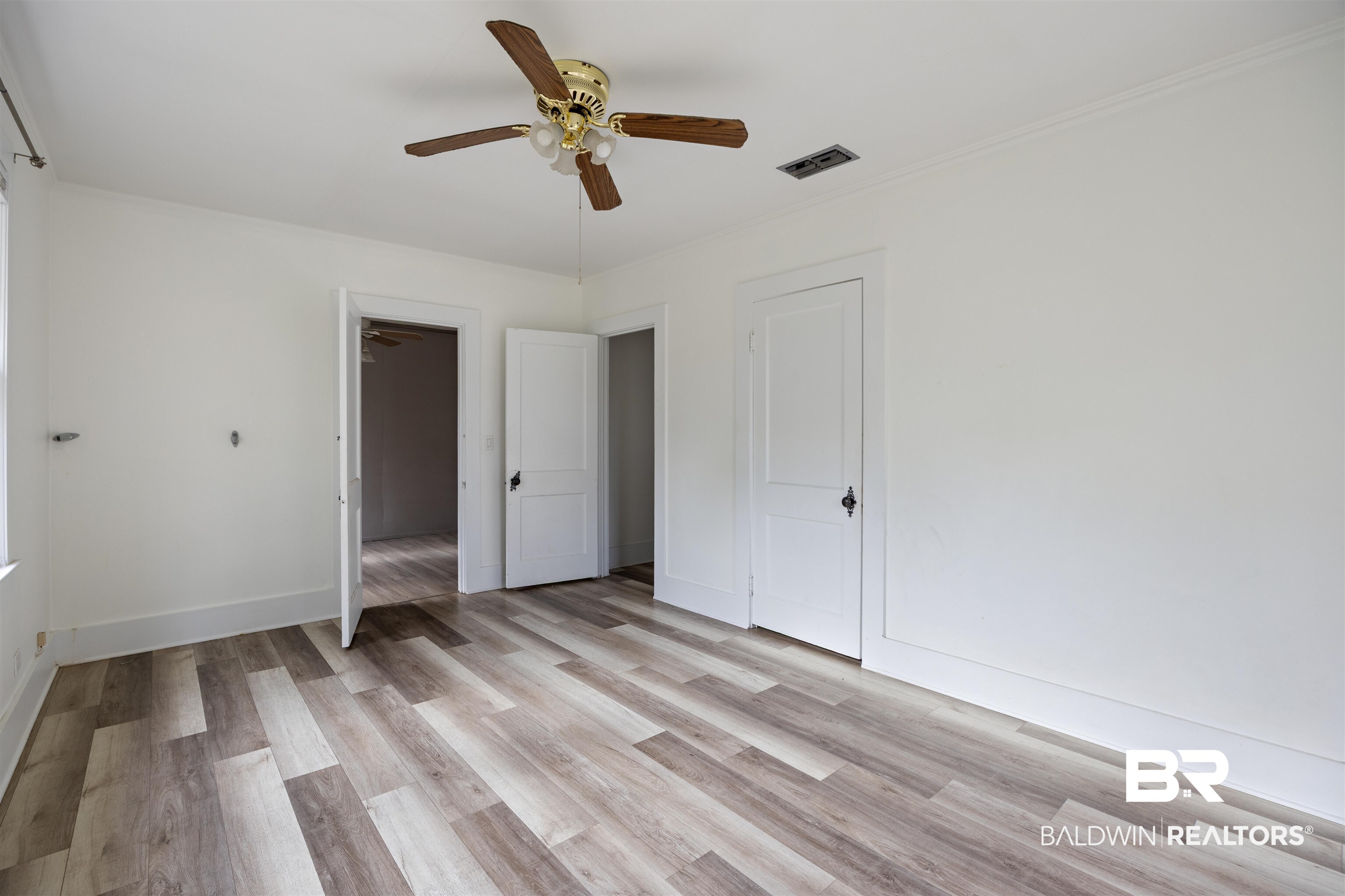 112 South Juniper Street Foley, AL 36535 - Photo 46 of 64 Unfurnished bedroom with light wood-type flooring and a ceiling fan