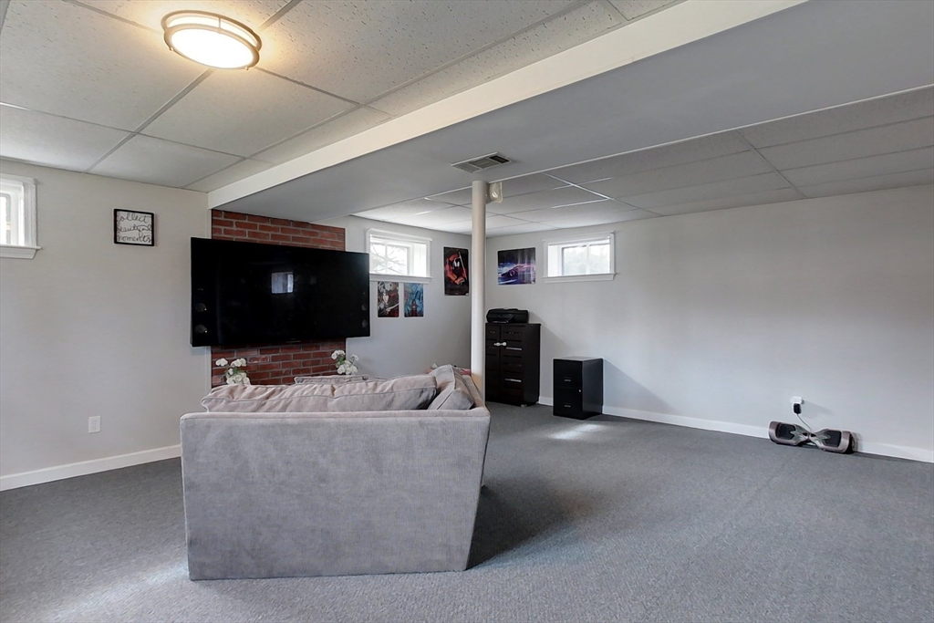 30 Haskell Road Pepperell, MA 01463 - Photo 20 of 30 a living room with furniture and a flat screen tv