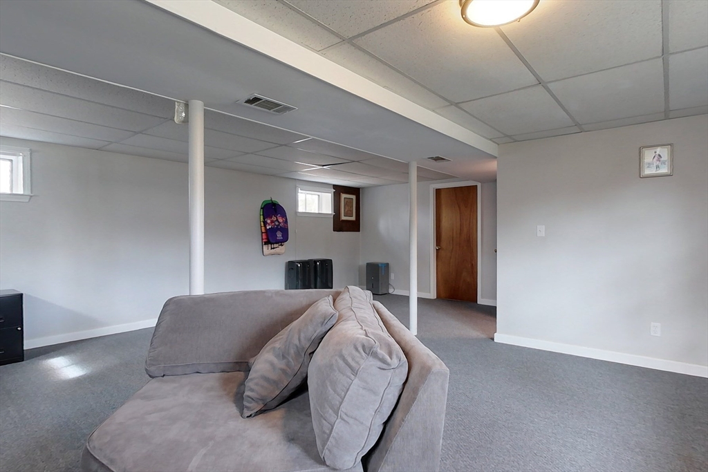 30 Haskell Road Pepperell, MA 01463 - Photo 21 of 30 a bedroom with a large bed and a chandelier