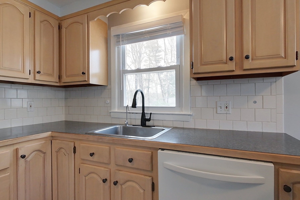30 Haskell Road Pepperell, MA 01463 - Photo 4 of 30 a kitchen with granite countertop white cabinets and a window
