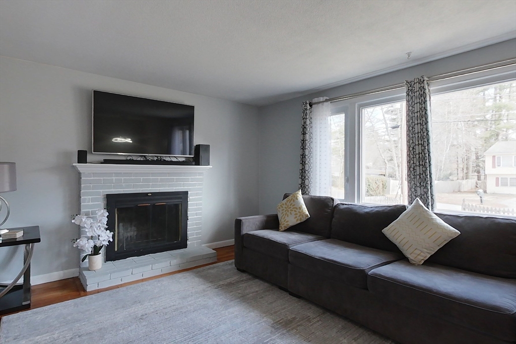 30 Haskell Road Pepperell, MA 01463 - Photo 8 of 30 a living room with furniture a flat screen tv and a fireplace