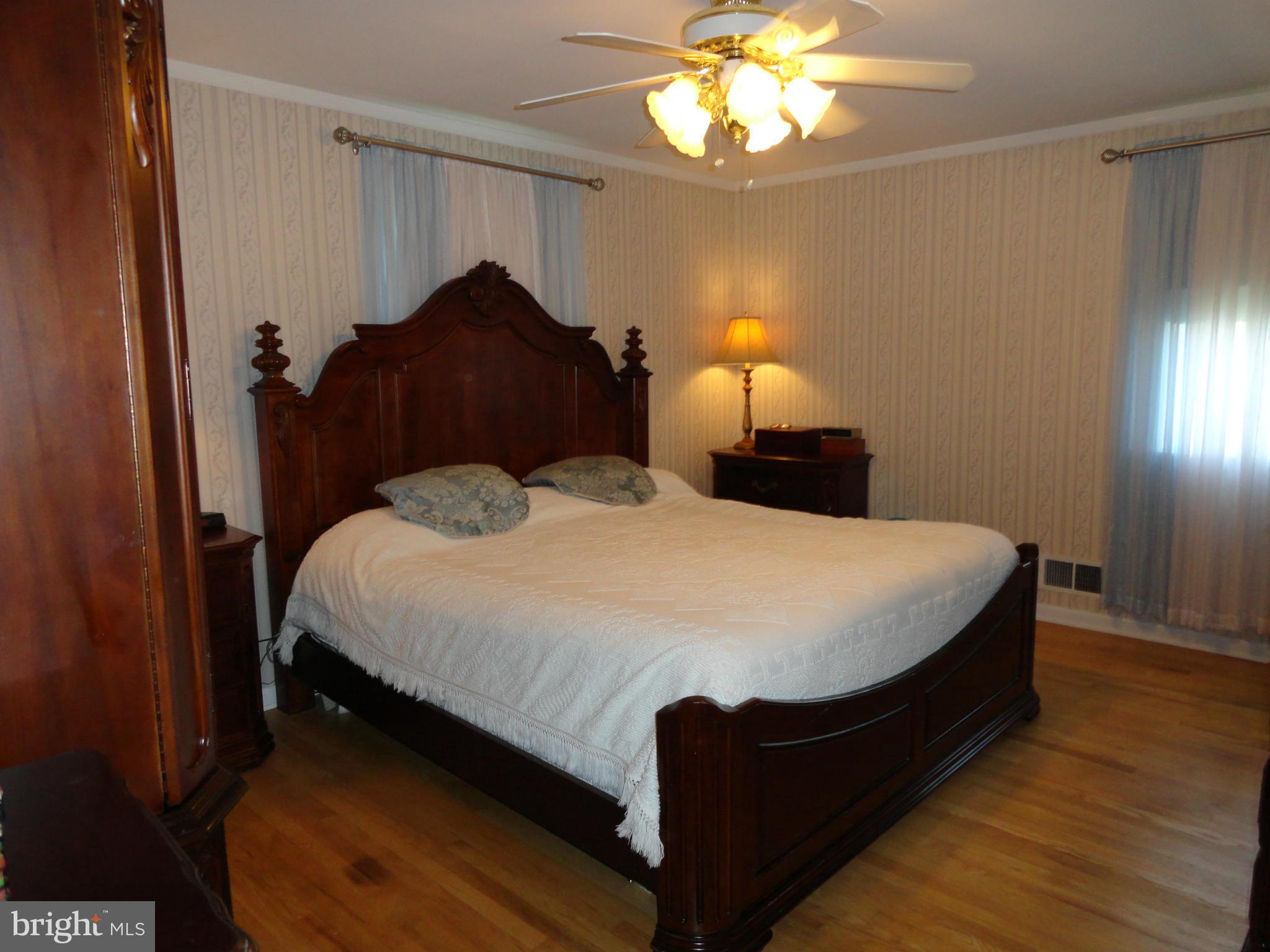 4317 Camellia Road Baltimore, MD 21236 - Photo 8 of 19 a bedroom with a bed and a chandelier