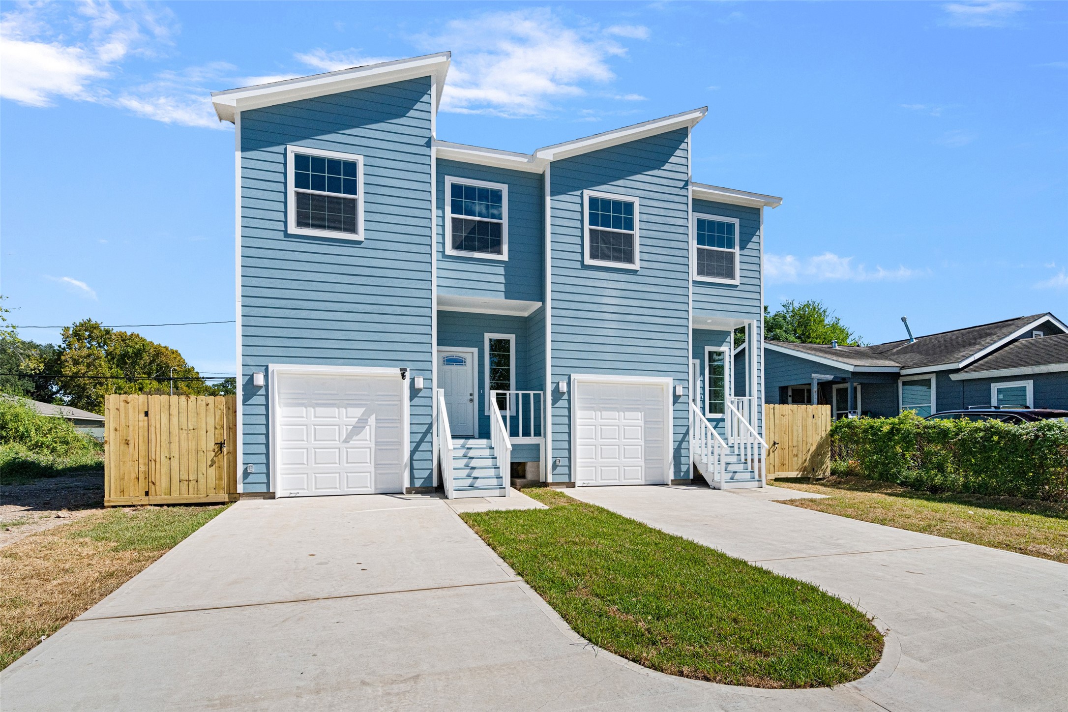 9409 Clinton Drive, Unit A Houston, TX 77029 - Photo 2 of 28 a front view of a house with a garden and plants