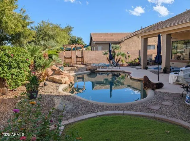 a view of a workspace with bookshelf and a window