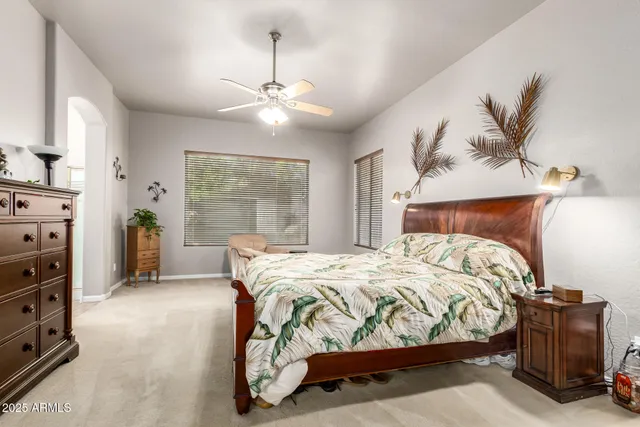 a bedroom with two beds and a window