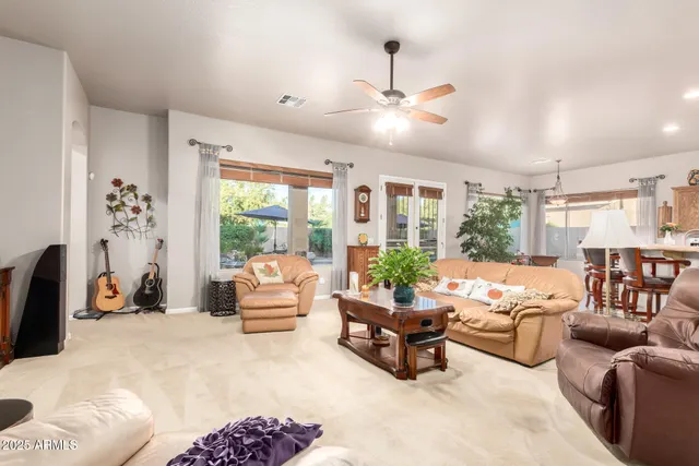 a kitchen with stainless steel appliances kitchen island granite countertop a refrigerator a sink dishwasher and a stove with wooden floor