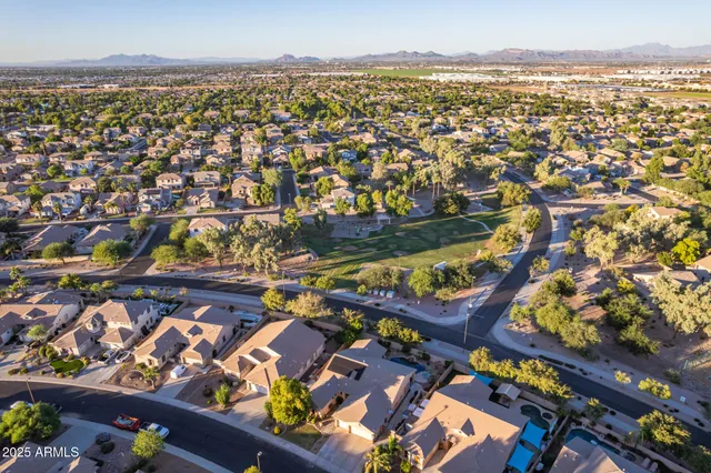an aerial view of residential houses with outdoor space