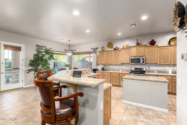 a kitchen with stainless steel appliances a sink stove refrigerator and cabinets
