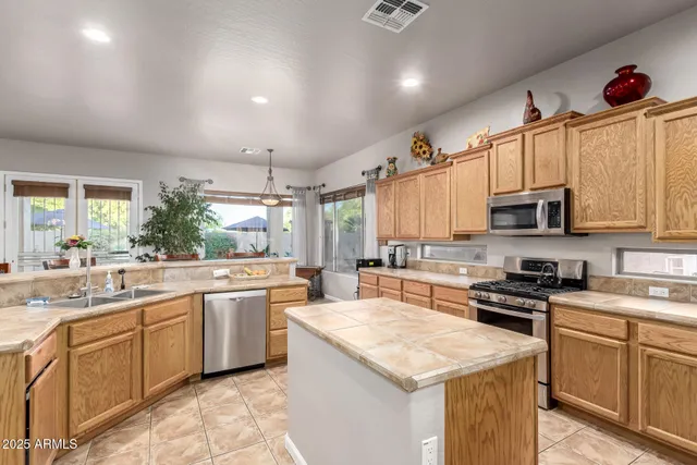 a view of a swimming pool with a table and chairs under an umbrella
