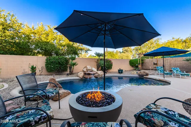 a view of a house with backyard and sitting area