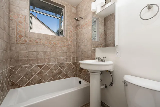 a bathroom with a sink a toilet and bathtub