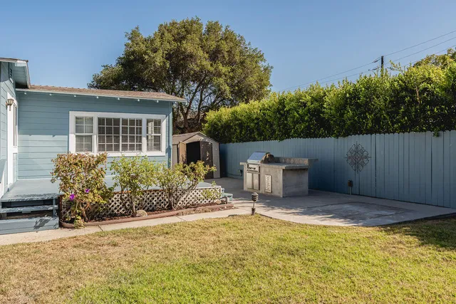 a view of a house with backyard and sitting area