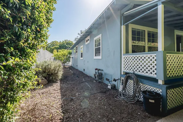a view of a house with a yard and sitting area