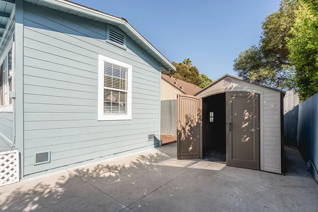 a view of a house with a door and wooden fence