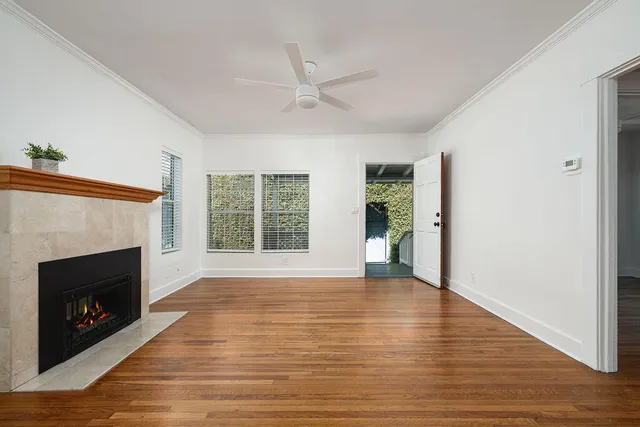 a view of an empty room with window and fire place