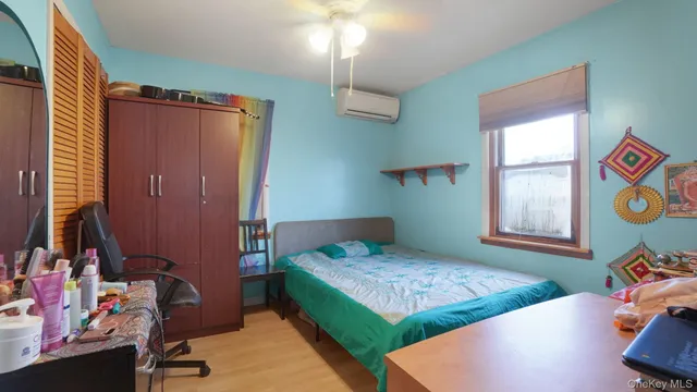 a bedroom with bed and a window