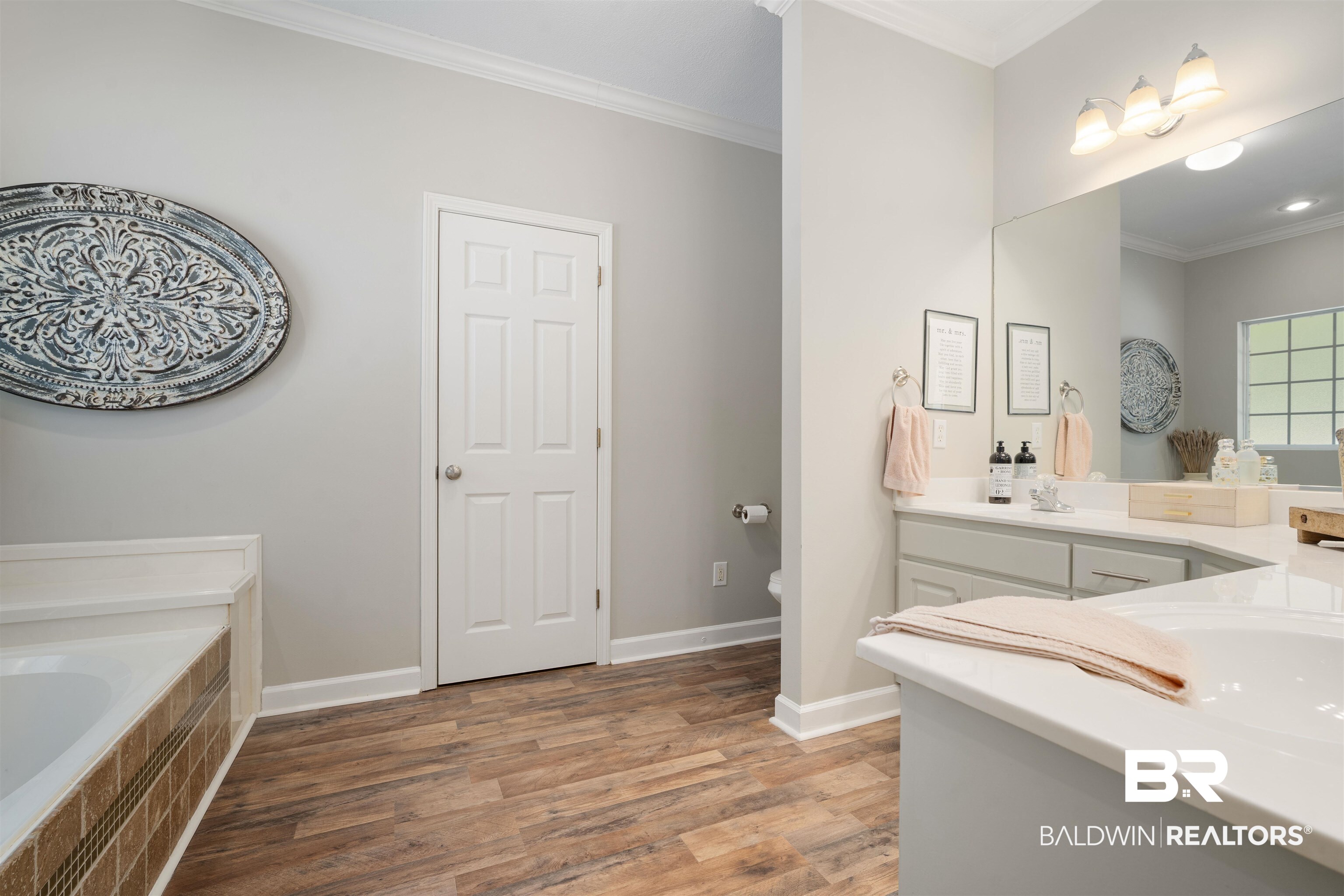 27288 Parker Lane Daphne, AL 36526 - Photo 14 of 29 Bathroom featuring ornamental molding, double vanity, light wood finished floors, and tiled bath