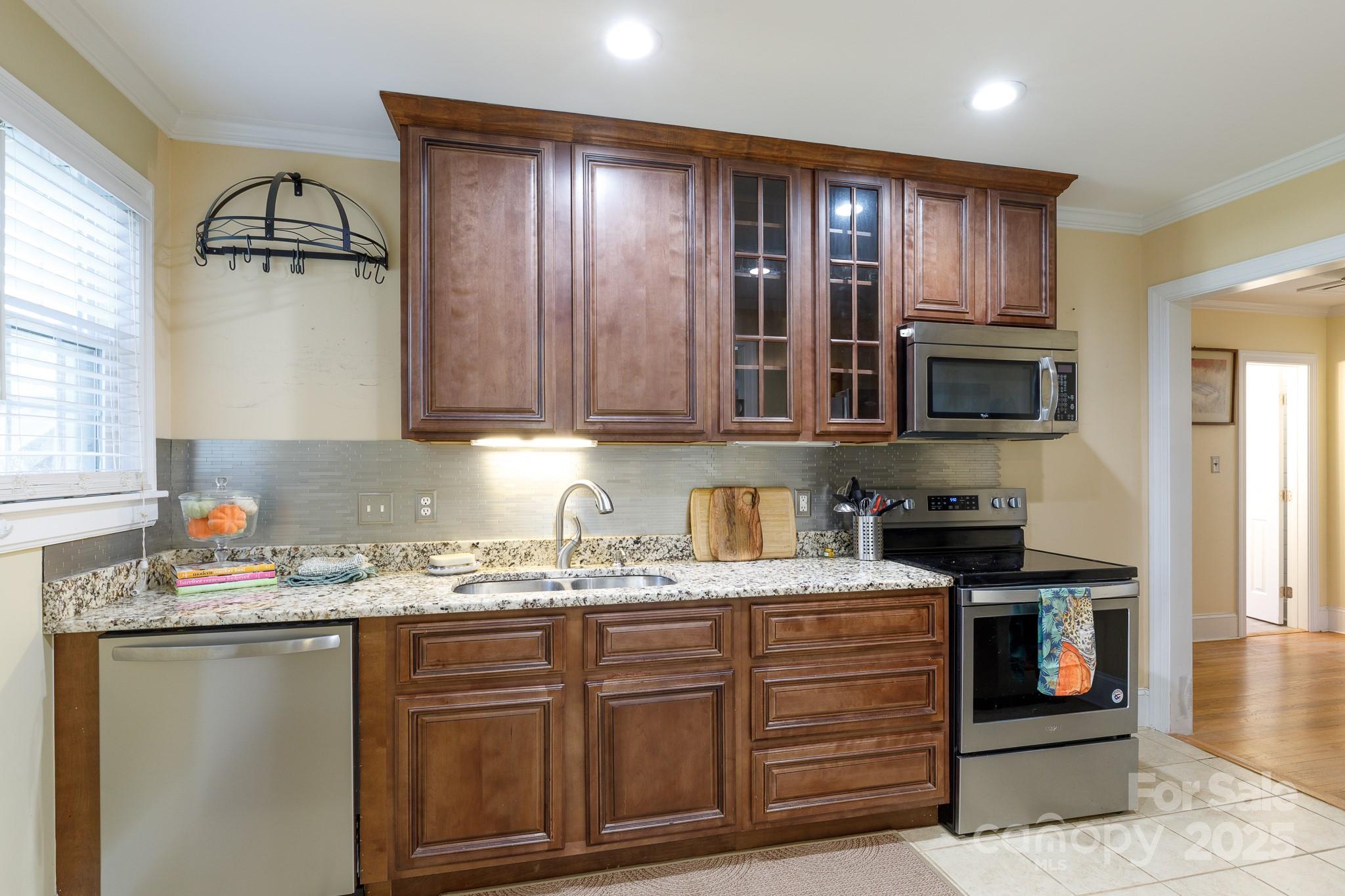 103 East Gregg Street Fort Mill, SC 29715 - Photo 9 of 47 a kitchen with stainless steel appliances granite countertop a sink stove and microwave