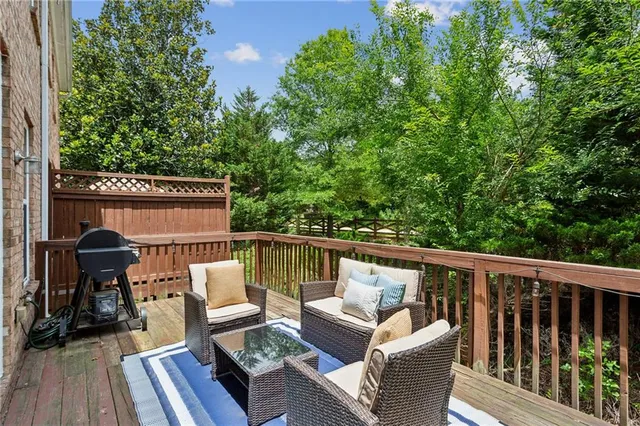 a balcony with wooden floor and outdoor seating