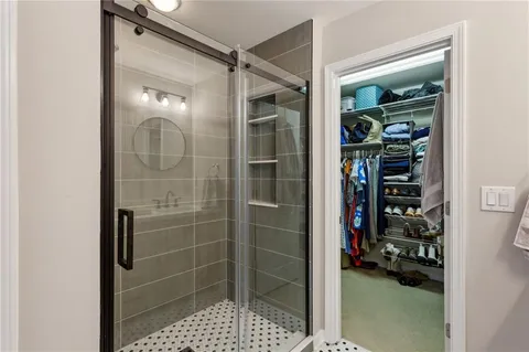 a bathroom with a glass shower door