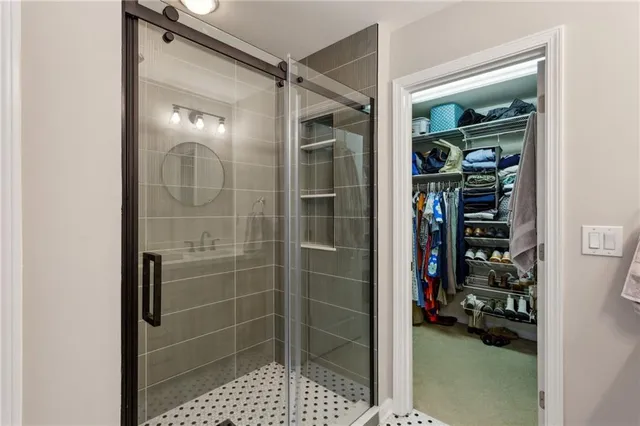 a bathroom with a glass shower door