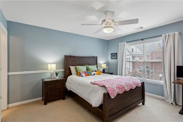 a bedroom with a bed chandelier and a window