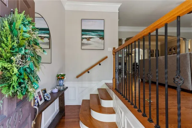 a view of entryway with wooden floor and stairs