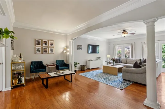 a living room with furniture and wooden floor