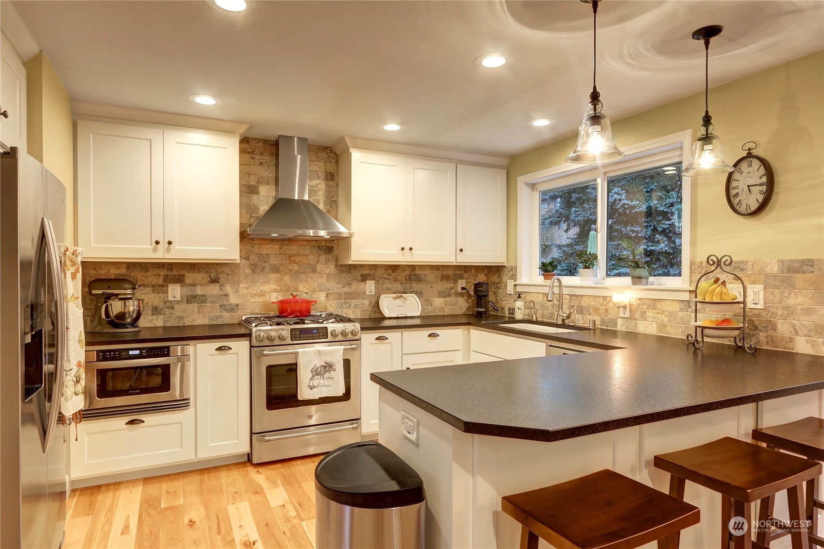120 219th Place Southwest Bothell, WA 98021 - Photo 3 of 20 a kitchen with a stove a sink and a refrigerator