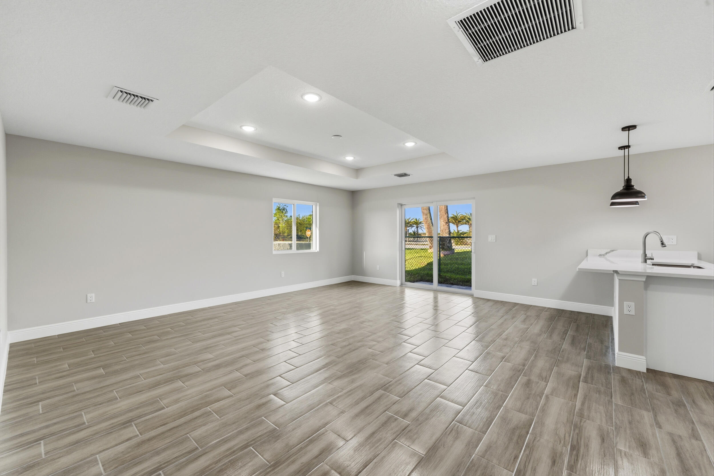 4335 Southwest 15th Way Okeechobee, FL 34974 - Photo 13 of 33 a view of an empty room with window and wooden floor
