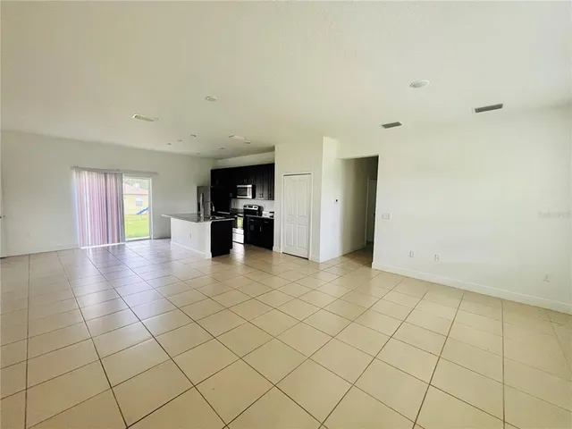 a kitchen with stainless steel appliances a refrigerator sink and white cabinets