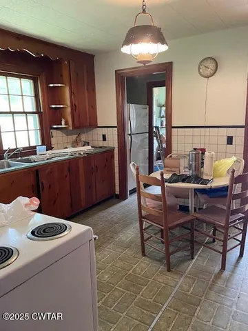 a kitchen with a dining table and chairs