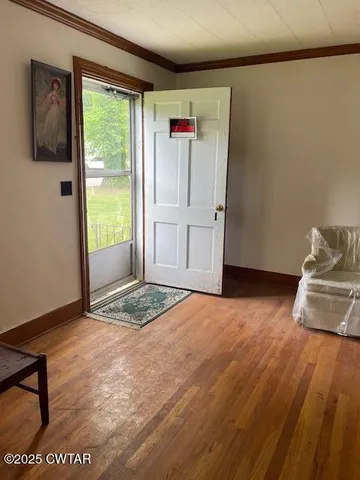 a view of livingroom with furniture and front door