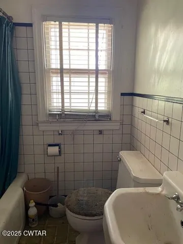 a bathroom with a toilet and a sink